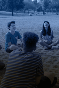 group of teenagers sitting outdoor in a circle
